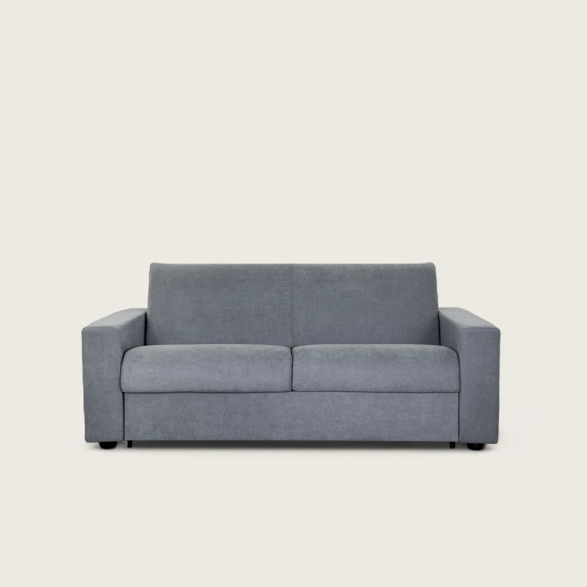 Il divano letto trasformabile in tessuto grigio con materasso integrato. Design moderno, materasso confortevole 140x190 cm e tessuto resistente. Perfetto per ogni ambiente.