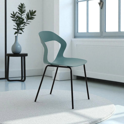 La sedia con seduta e schienale in polipropilene e gambe in metallo nero. Colore petrolio, design elegante e materiali resistenti, perfetta per arredare interni con stile e comfort.